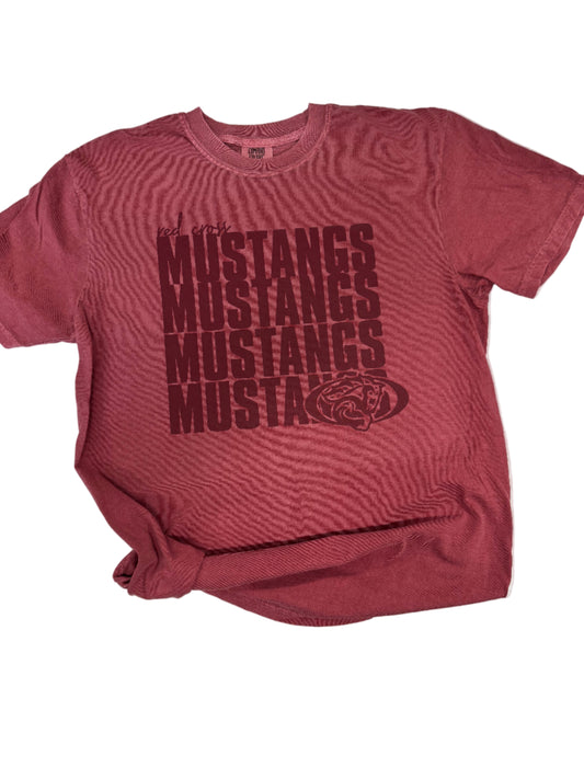 Maroon tank top with 'Mustangs' text on a white surface
